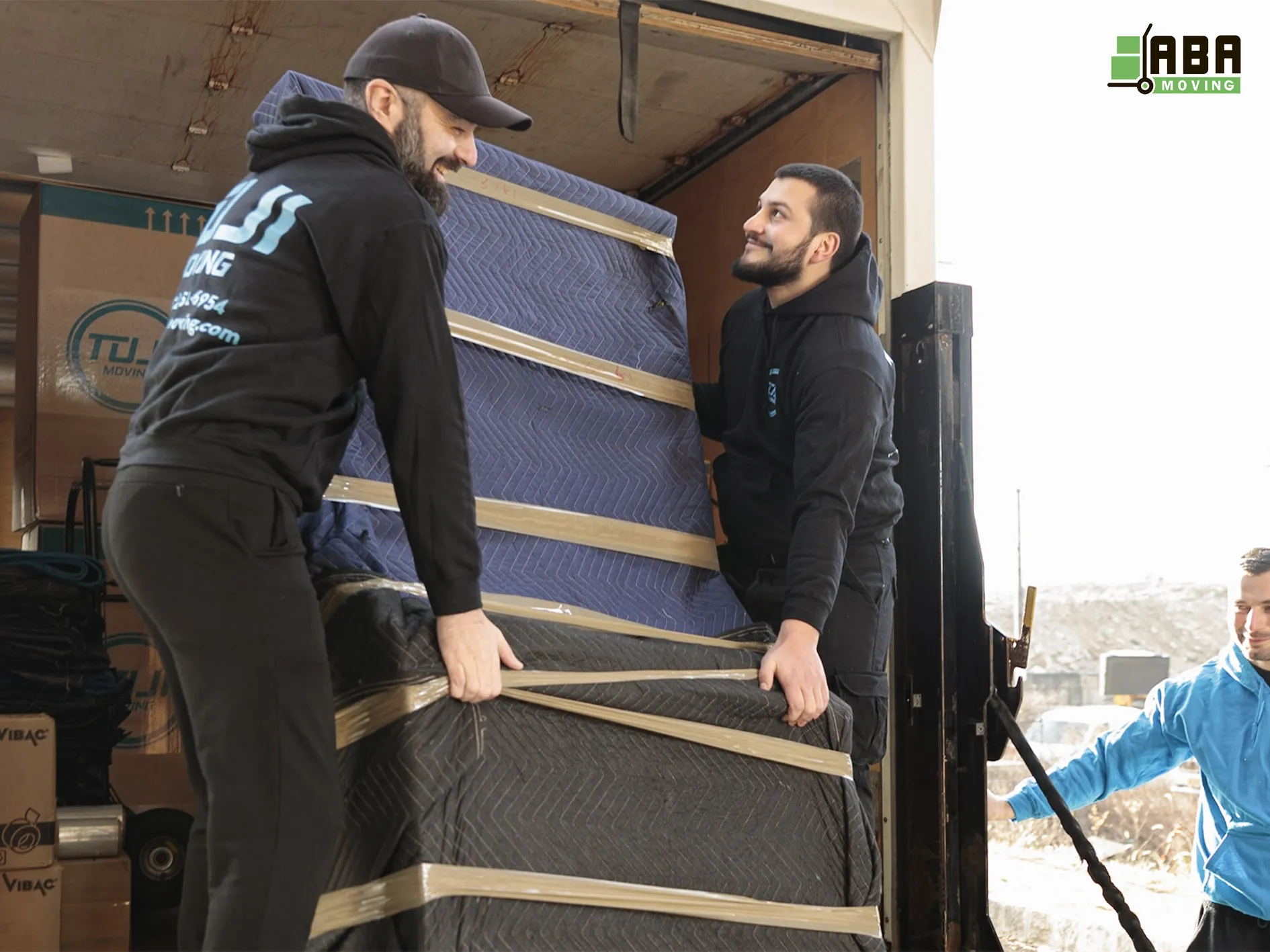 Piano Moving Team Members Loading Instrument in Truck