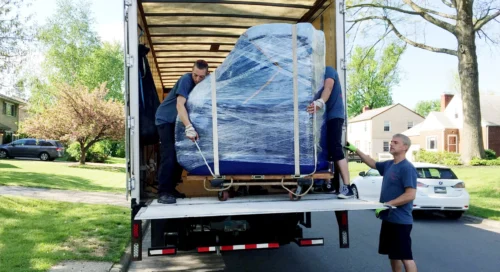 Piano Moving Team Members Unloading Instrument from Truck
