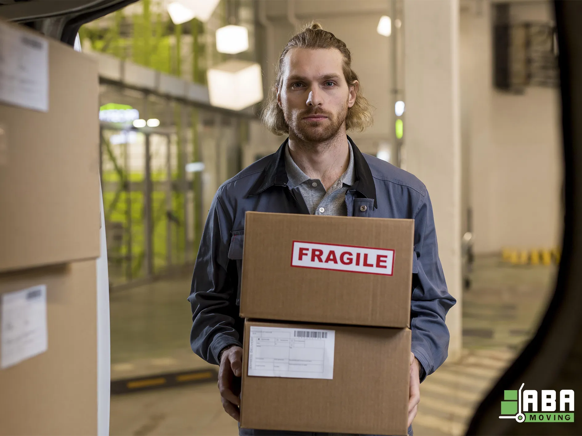 Storage Service Team Member Unloading Customer Boxes From Truck Before Loading in Personal Storage